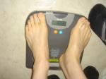 Trent's feet while weighing himself on a scale