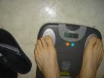 Trent's feet while weighing himself on a scale