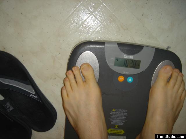 Trent's feet while weighing himself on a scale