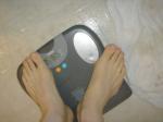 Trent's feet while weighing himself on a scale