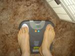 Trent's feet while weighing himself on a scale