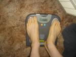 Trent's feet while weighing himself on a scale