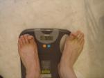Trent's feet while weighing himself on a scale