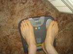 Trent's feet while weighing himself on a scale