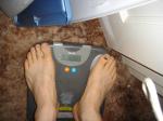 Trent's feet while weighing himself on a scale