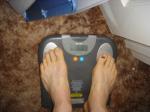 Trent's feet while weighing himself on a scale