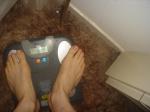 Trent's feet while weighing himself on a scale