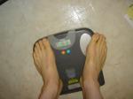 Trent's feet while weighing himself on a scale