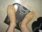Trent's feet while weighing himself on a scale