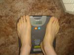 Trent's feet while weighing himself on a scale