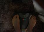 Trent's feet while weighing himself on a scale
