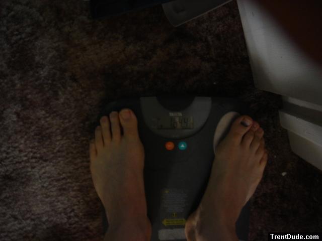 Trent's feet while weighing himself on a scale