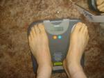 Trent's feet while weighing himself on a scale