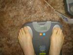 Trent's feet while weighing himself on a scale