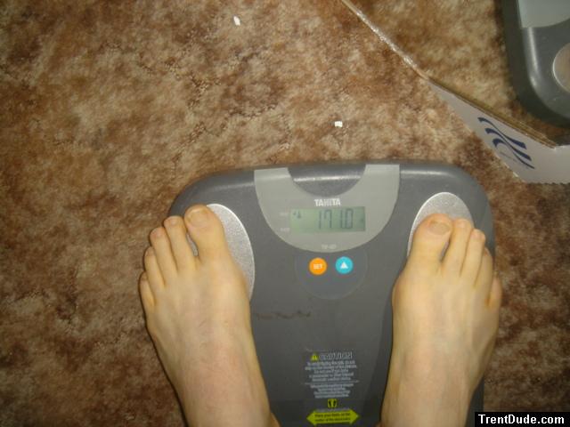 Trent's feet while weighing himself on a scale