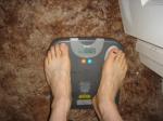 Trent's feet while weighing himself on a scale