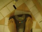 Trent's feet while weighing himself on a scale