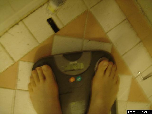 Trent's feet while weighing himself on a scale