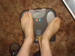 Trent's feet while weighing himself on a scale