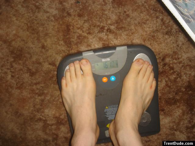 Trent's feet while weighing himself on a scale