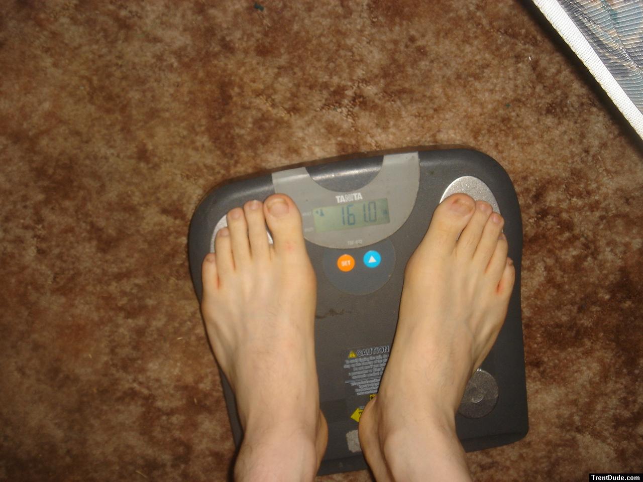Trent's feet while weighing himself on a scale