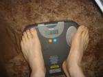 Trent's feet while weighing himself on a scale