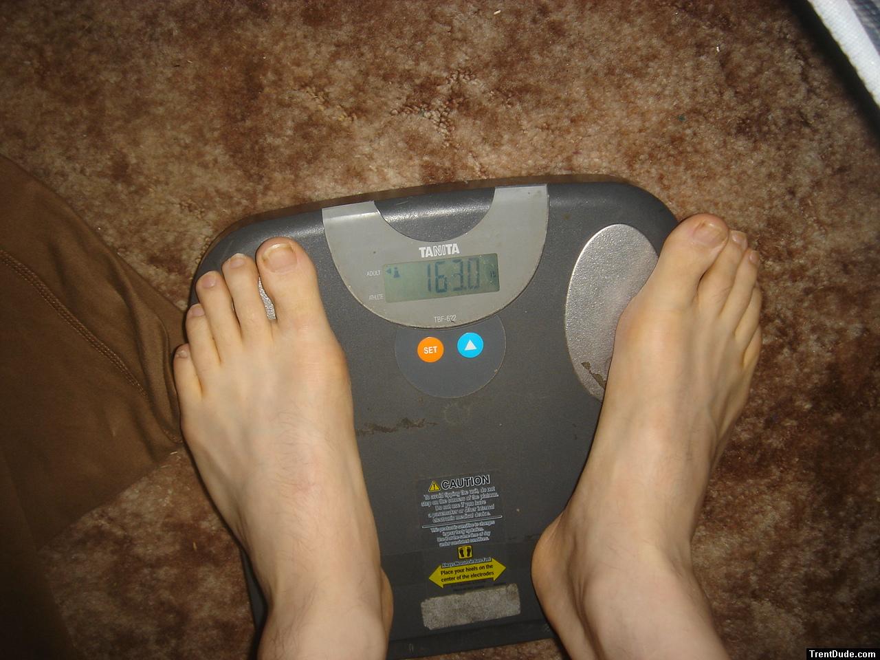 Trent's feet while weighing himself on a scale