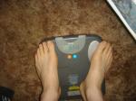Trent's feet while weighing himself on a scale
