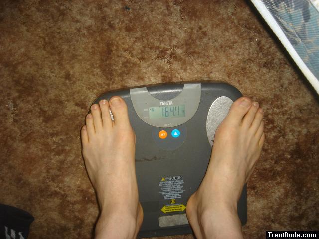 Trent's feet while weighing himself on a scale