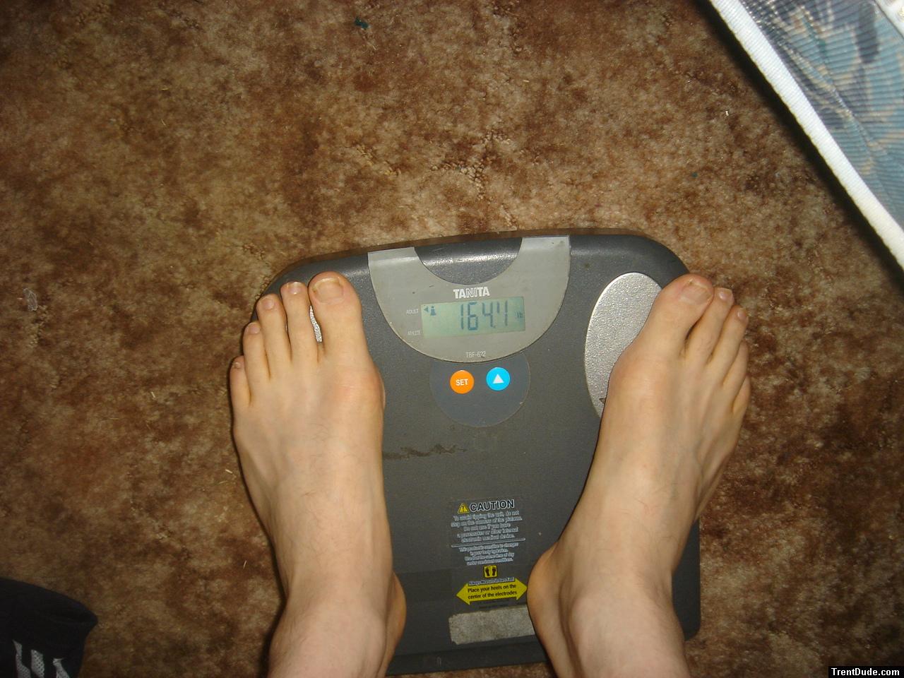 Trent's feet while weighing himself on a scale