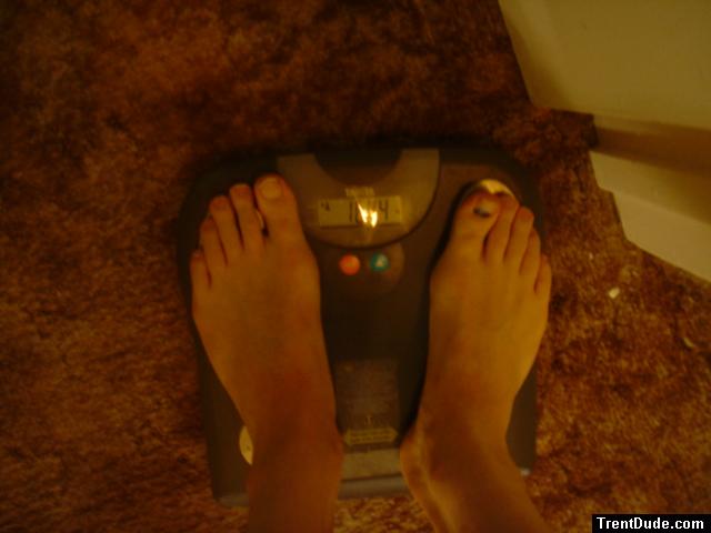 Trent's feet while weighing himself on a scale