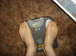 Trent's feet while weighing himself on a scale
