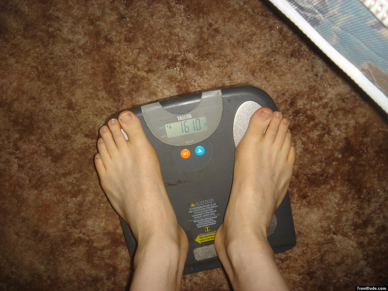 Trent's feet while weighing himself on a scale