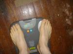 Trent's feet while weighing himself on a scale
