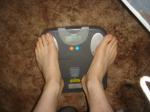 Trent's feet while weighing himself on a scale