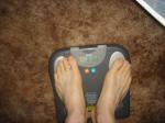 Trent's feet while weighing himself on a scale