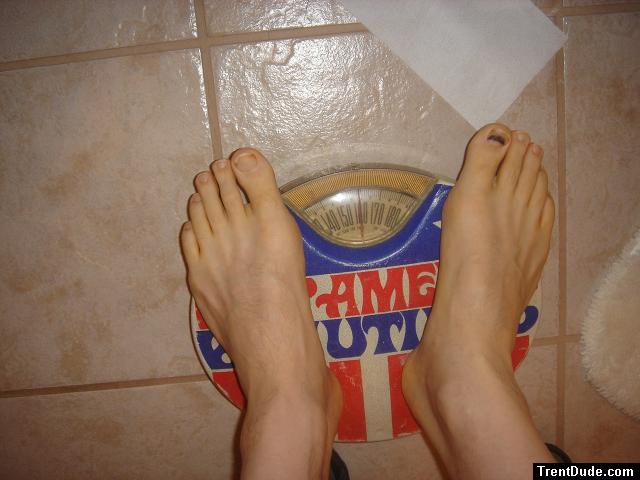 Trent's feet while weighing himself on a scale