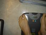 Trent's feet while weighing himself on a scale