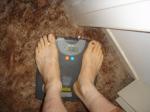 Trent's feet while weighing himself on a scale