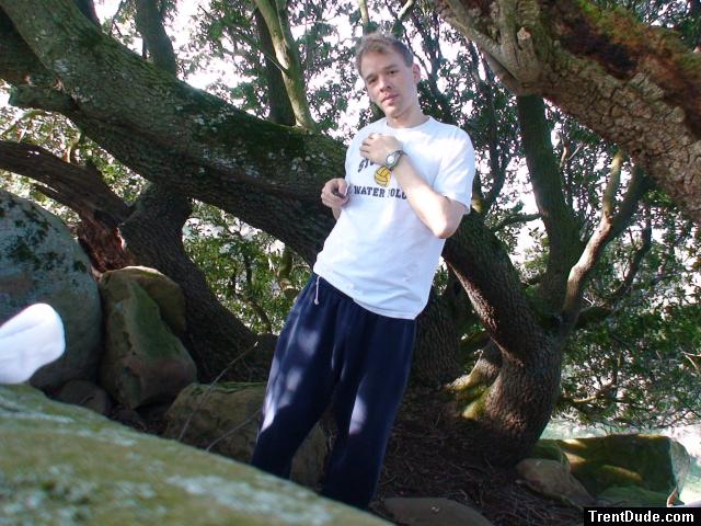 dude wearing sweats and  t-shirt in the trees