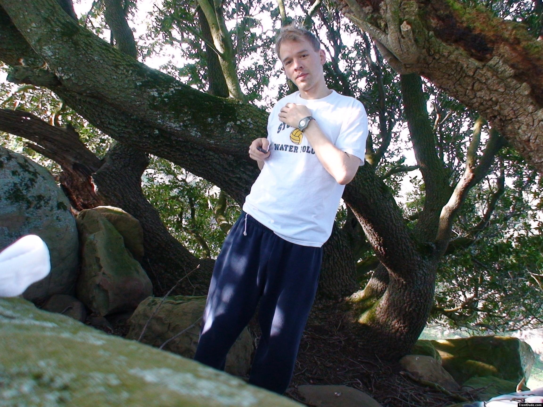 dude wearing sweats and  t-shirt in the trees