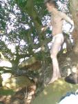 A guy exploring the forest in a string bikini