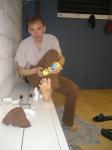 Applying Desenex Antifungal powder to his foot to prevent athlete's foot (Miconazole Nitrate)