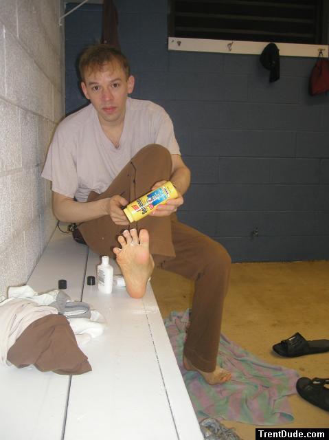 Applying Desenex Antifungal powder to his foot to prevent athlete's foot (Miconazole Nitrate)