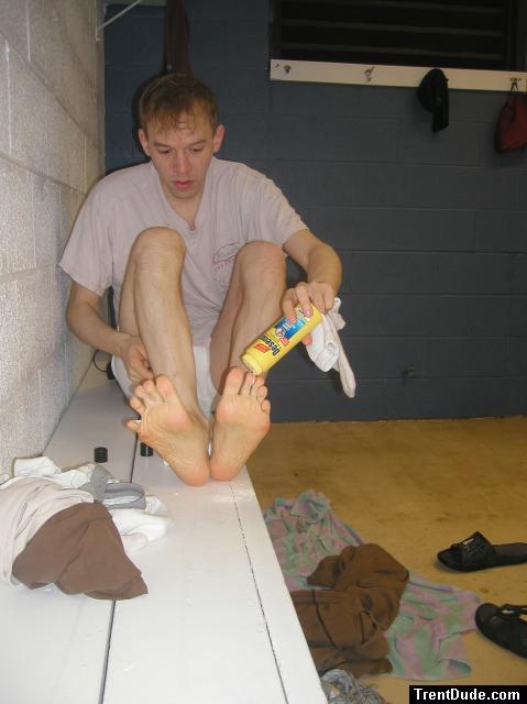 Applying Desenex Antifungal powder to his foot to prevent athlete's foot (Miconazole Nitrate)