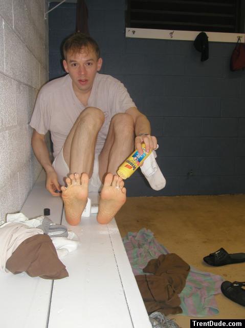 Applying Desenex Antifungal powder to his foot to prevent athlete's foot (Miconazole Nitrate)