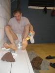 Applying Desenex Antifungal powder to his foot to prevent athlete's foot (Miconazole Nitrate)
