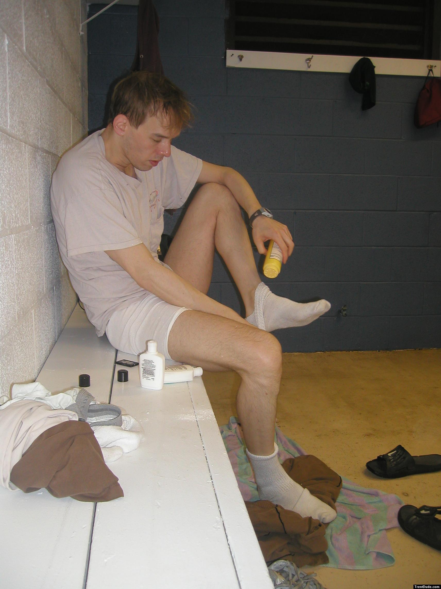 Applying Desenex Antifungal powder to his foot to prevent athlete's foot (Miconazole Nitrate)