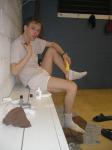 Applying Desenex Antifungal powder to his foot to prevent athlete's foot (Miconazole Nitrate)