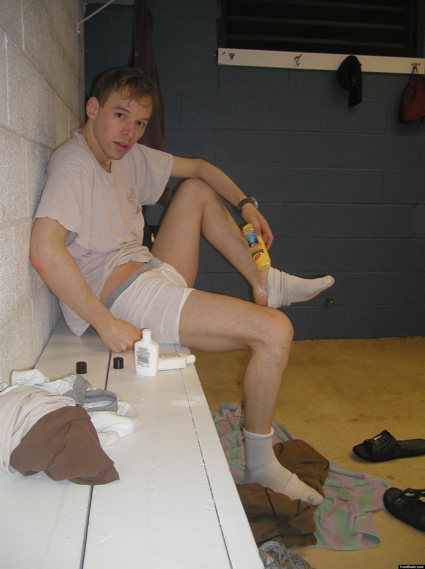 Applying Desenex Antifungal powder to his foot to prevent athlete's foot (Miconazole Nitrate)